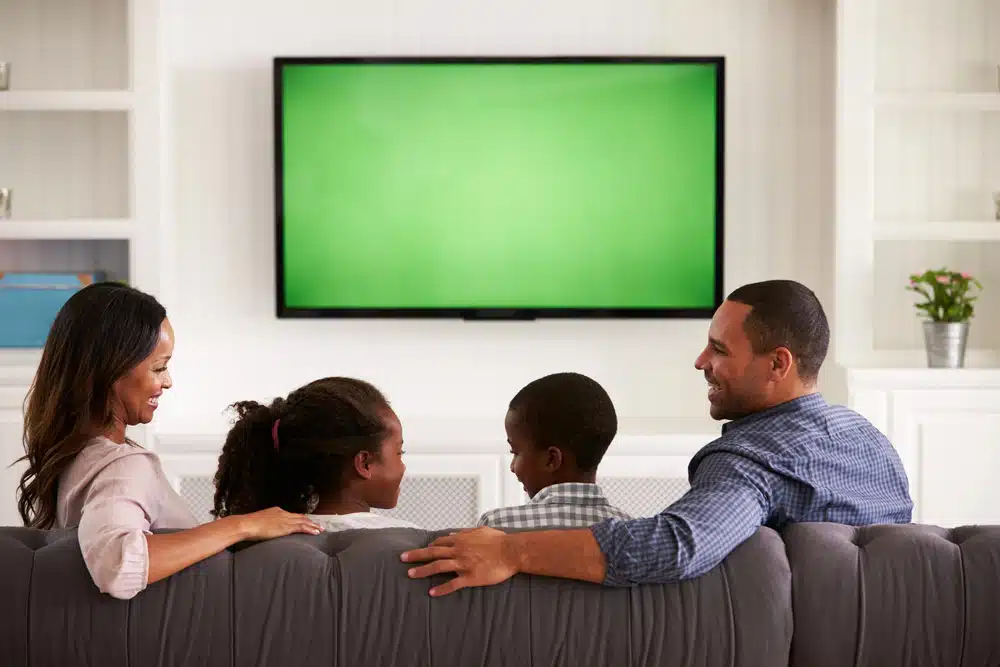 family watching TV on wall