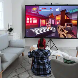 Girl plays video game on projector screen, highlighting exciting home theater benefits for kids