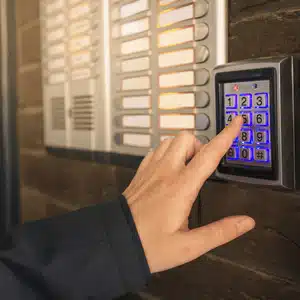 User enters security code on keypad intercom, showing how intercom works via PIN