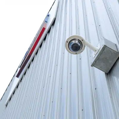 Security camera mounted on a metal wall outdoors, showing differences in indoor vs outdoor security cameras