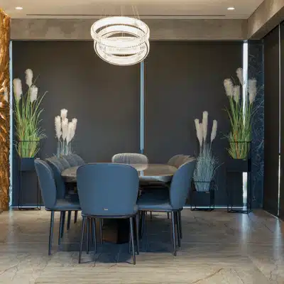 Dining room with dark roller shades; example for explaining what are motorized blinds and benefits